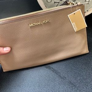Michael Kohrs large wristlet . Nude color.